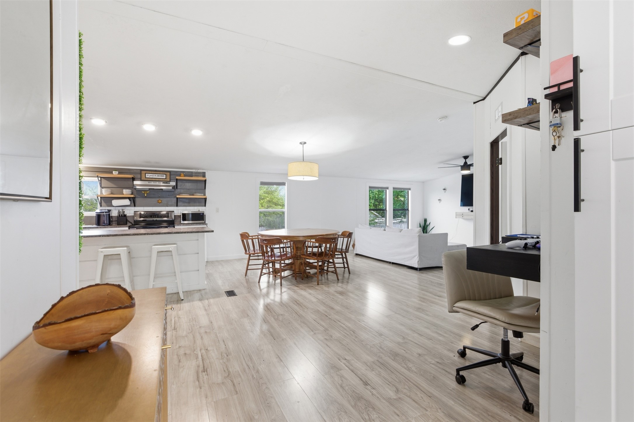 580 Railyard Drive Kyle, TX 78640 - Photo 6 of 20 Open-concept living space featuring light-toned flooring, recessed lighting, and large windows providing natural light