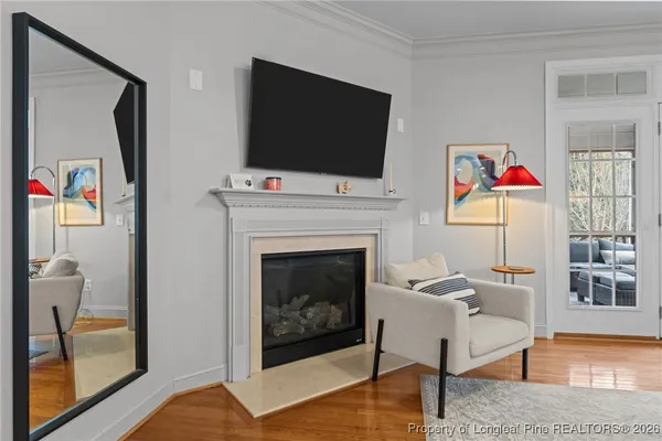 a living room with furniture fireplace and flat screen tv