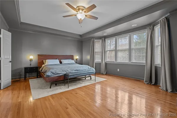 a bedroom with a large bed and a chandelier