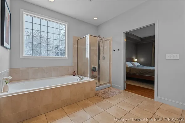 a bathroom with a tub and a shower