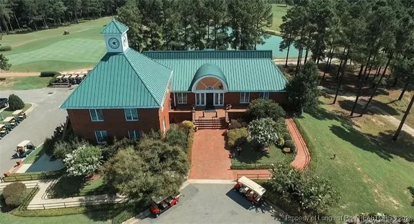an aerial view of a house with a yard and potted plants