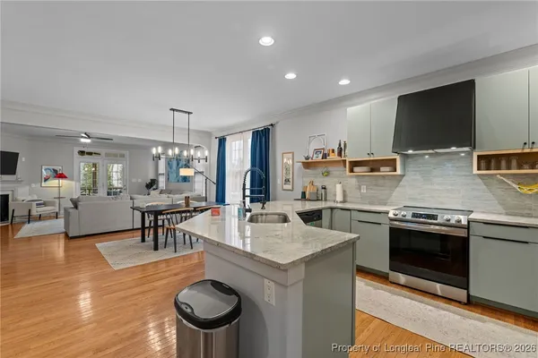 a kitchen with stainless steel appliances granite countertop a sink and a stove