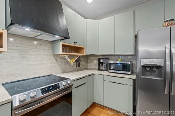a kitchen with a stove microwave and refrigerator