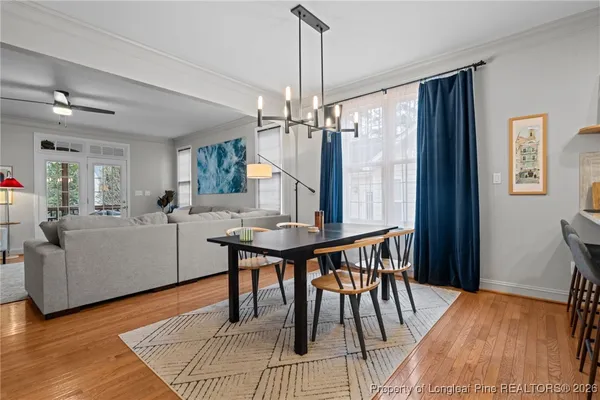 a living room with furniture a table and wooden floor