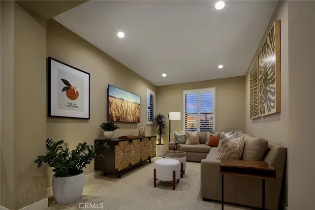 a living room with furniture and flowers