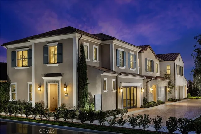 a front view of a house with lots of green space