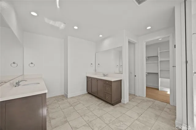 a view of a city from a balcony with seating space