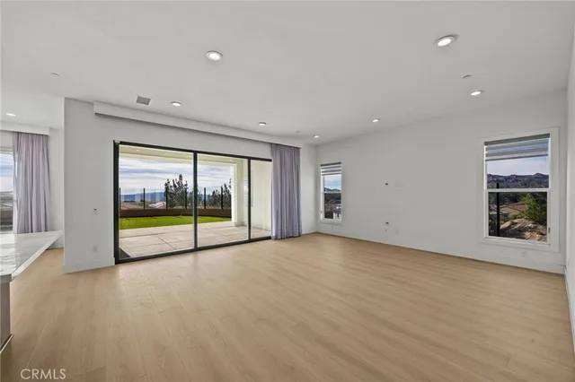 a view of an empty room with a window and a room