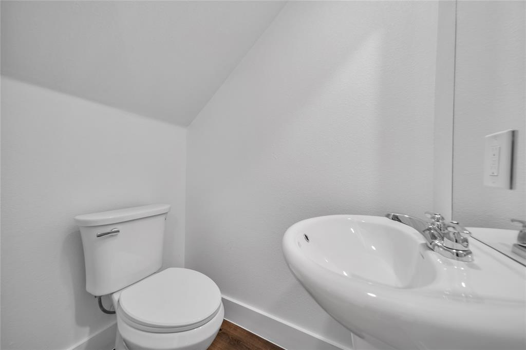 1128 Newton Road Ferris, TX 75125 - Photo 10 of 19 Unfurnished bedroom with dark wood-style floors and a ceiling fan