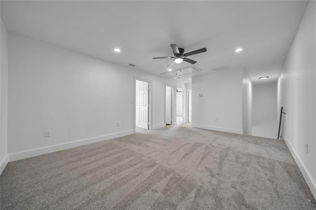 1128 Newton Road Ferris, TX 75125 - Photo 12 of 19 Unfurnished bedroom with attic access, light colored carpet, ceiling fan, and recessed lighting