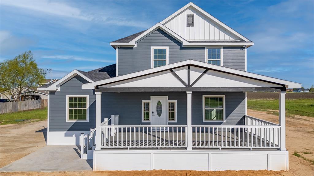 1128 Newton Road Ferris, TX 75125 - Photo 16 of 19 View of front facade with a porch, board and batten siding, and a shingled roof