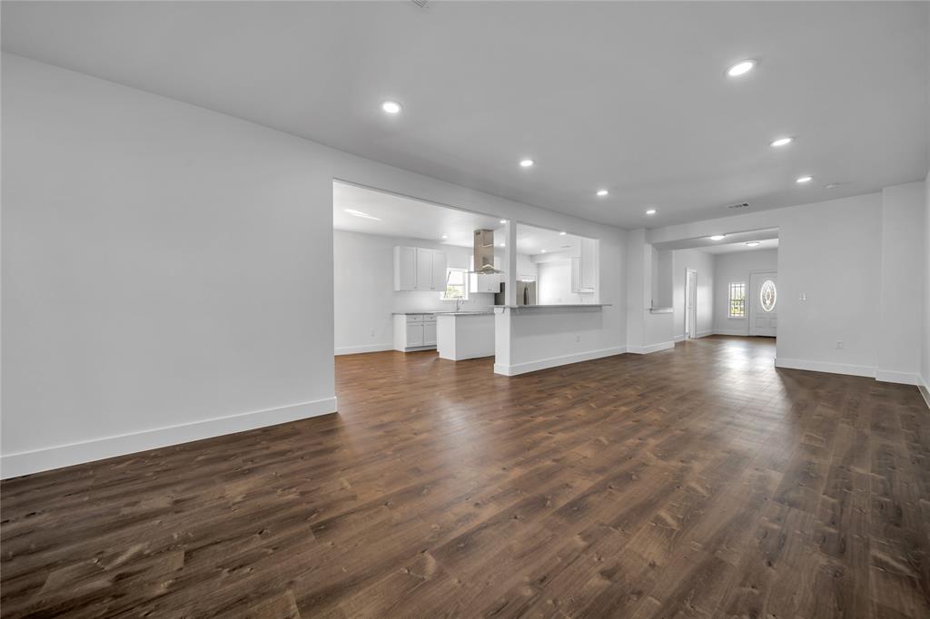1128 Newton Road Ferris, TX 75125 - Photo 2 of 19 Unfurnished living room featuring recessed lighting and dark wood-style floors