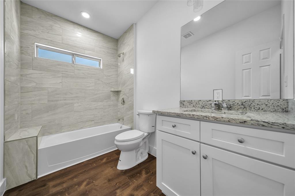1128 Newton Road Ferris, TX 75125 - Photo 9 of 19 Bathroom featuring shower / washtub combination, vanity, dark wood-style flooring, and recessed lighting