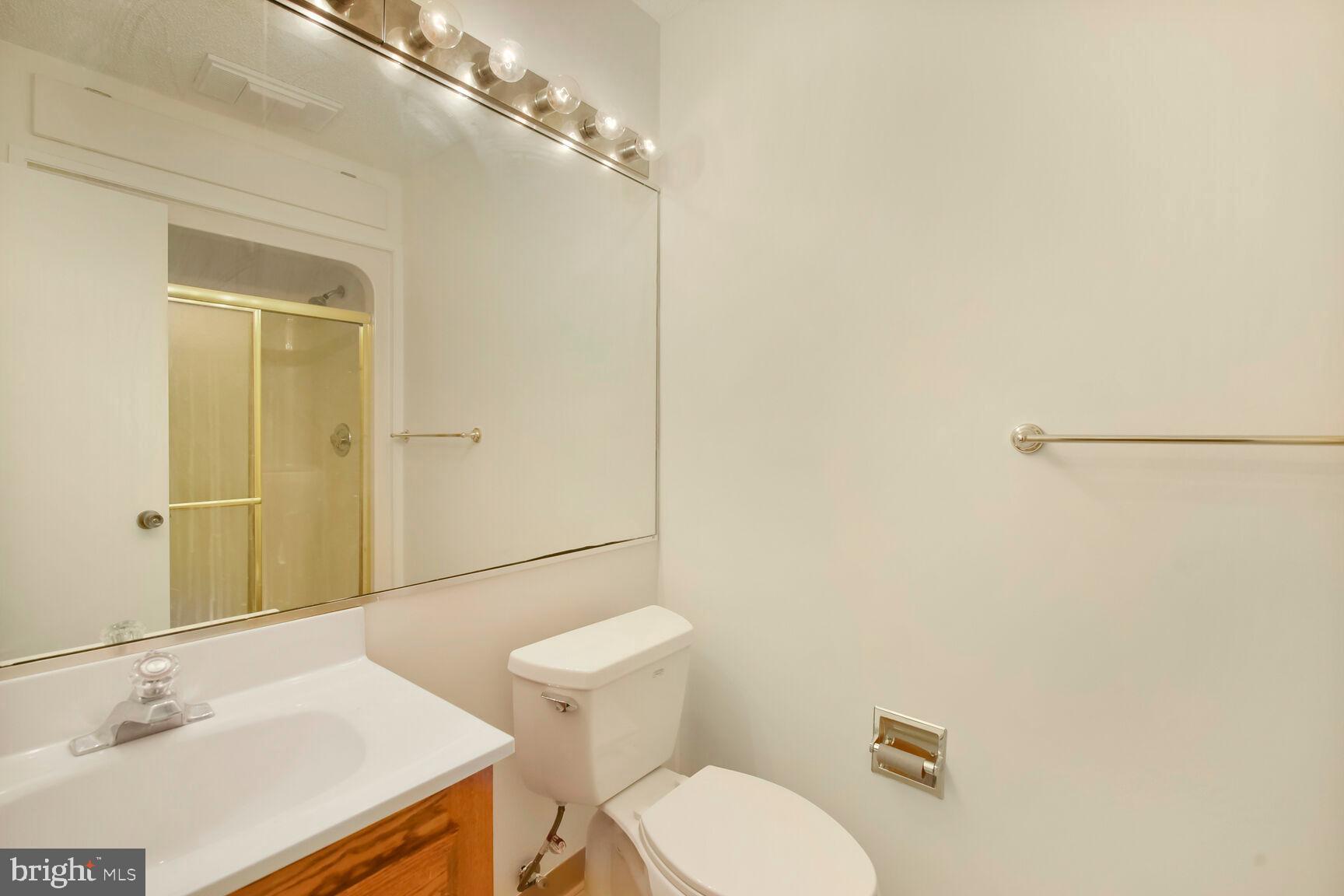 13417 Elevation Lane Herndon, VA 20171 - Photo 12 of 30 a bathroom with a sink a toilet and shower