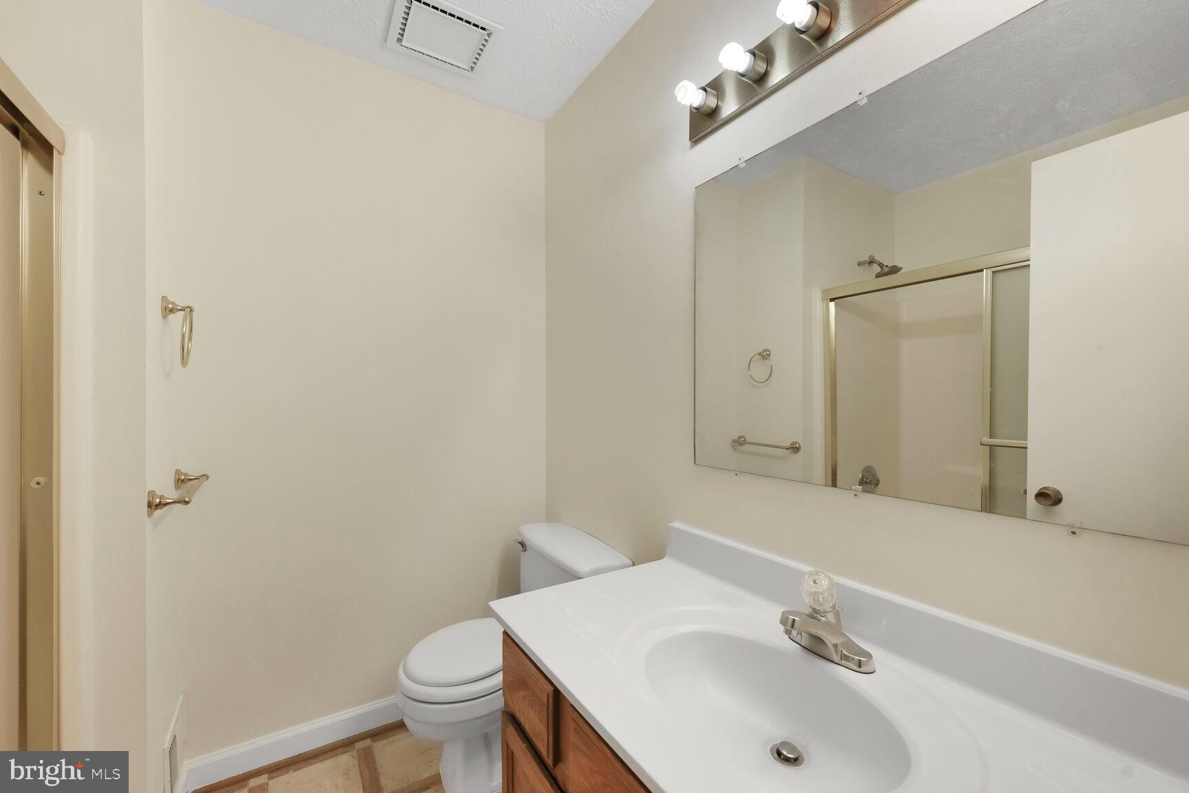 13417 Elevation Lane Herndon, VA 20171 - Photo 15 of 30 a bathroom with a sink toilet and a mirror