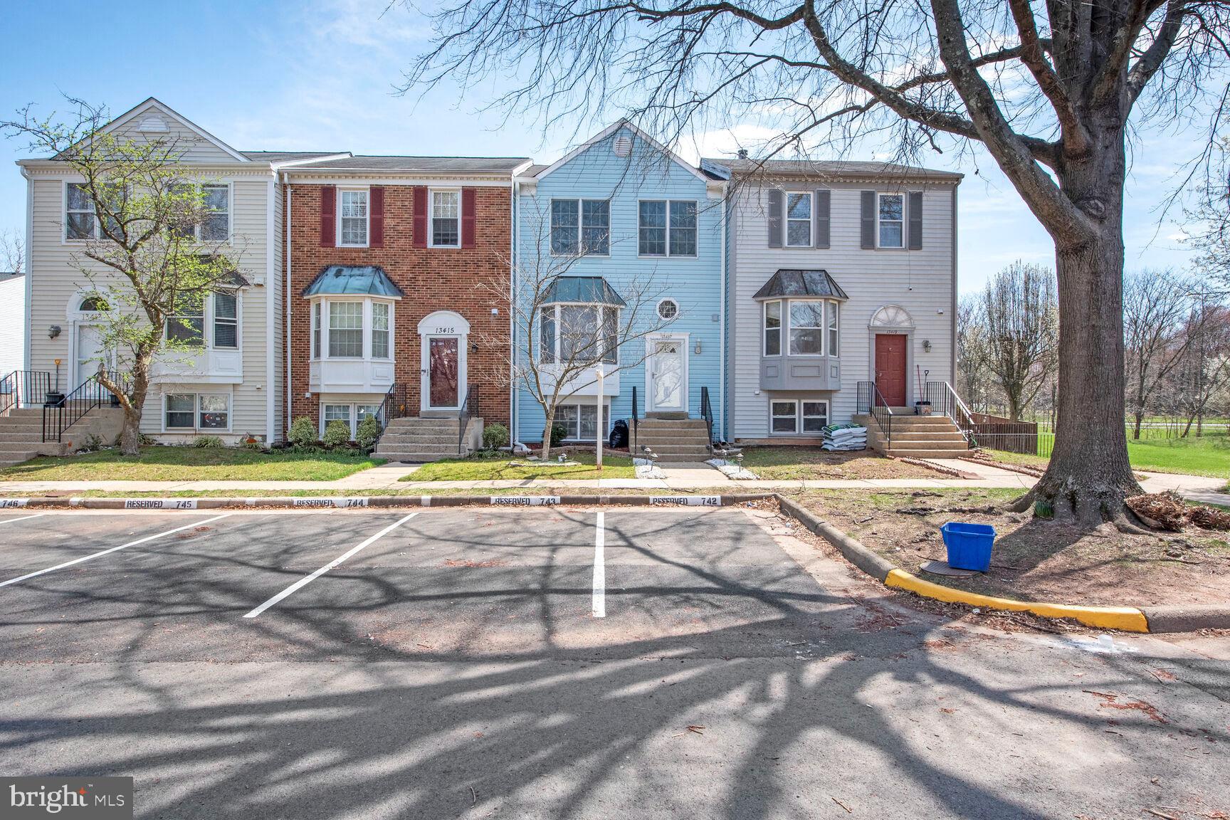 13417 Elevation Lane Herndon, VA 20171 - Photo 2 of 30 a view of a large building with a large tree and plants