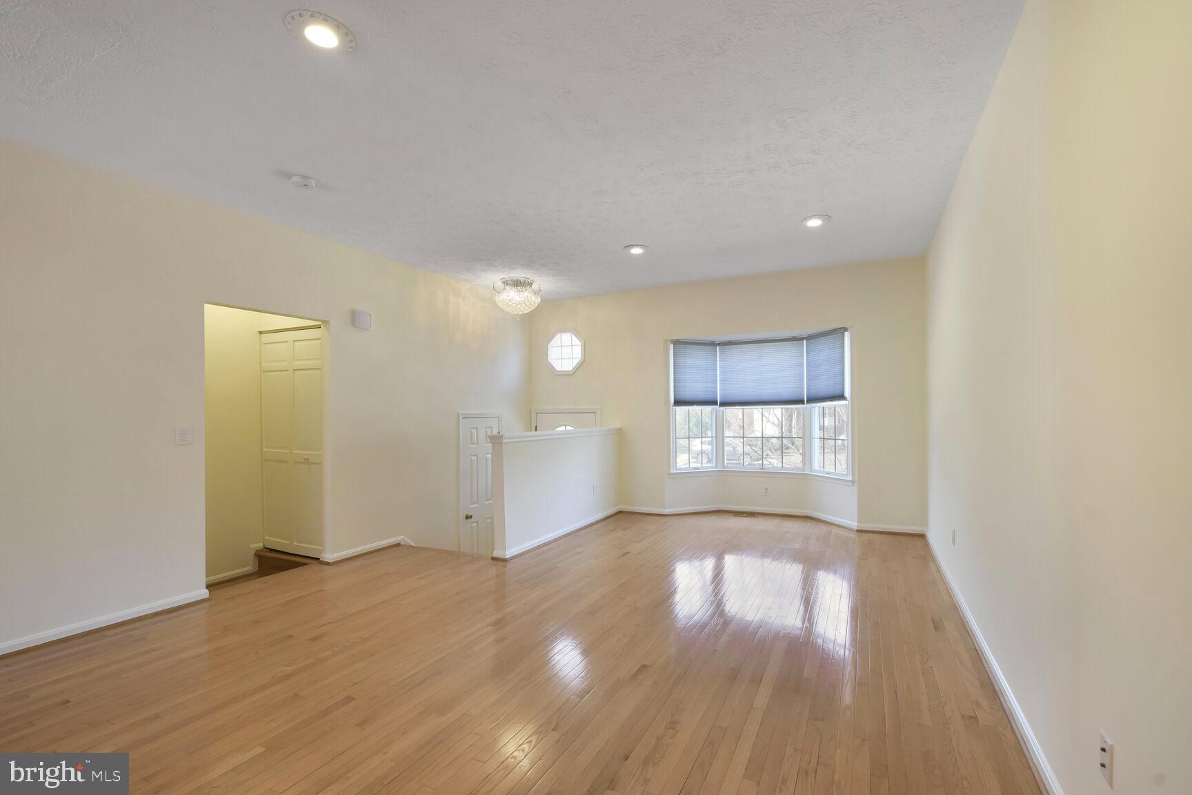 13417 Elevation Lane Herndon, VA 20171 - Photo 4 of 30 an empty room with wooden floor and windows