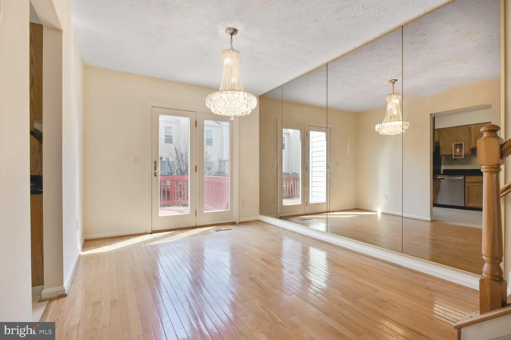 13417 Elevation Lane Herndon, VA 20171 - Photo 5 of 30 a view of an empty room with window and wooden floor