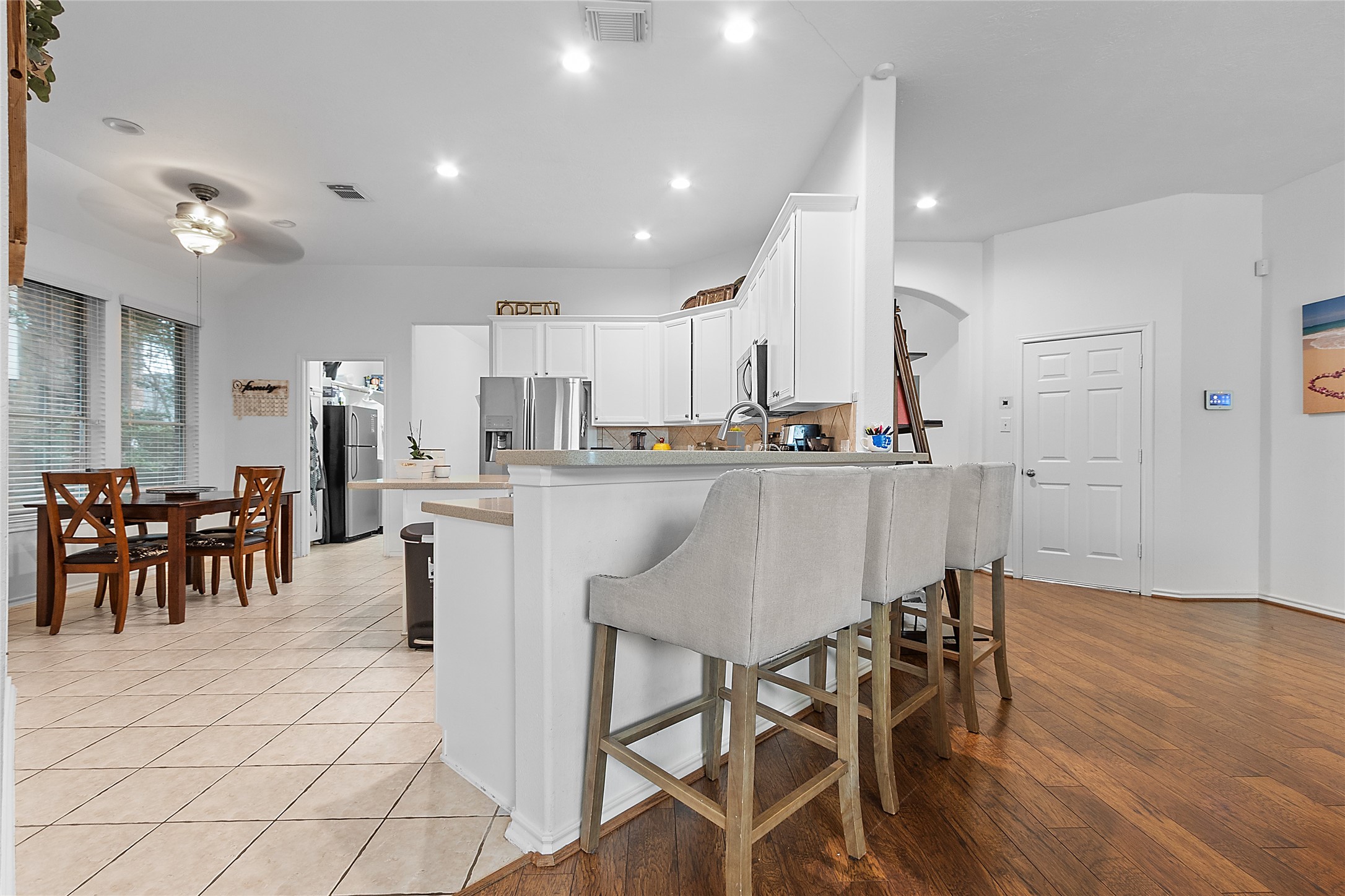 21014 Jessica Rose Lane Spring, TX 77379 - Photo 9 of 30 a kitchen with stainless steel appliances a dining table chairs and wooden floor