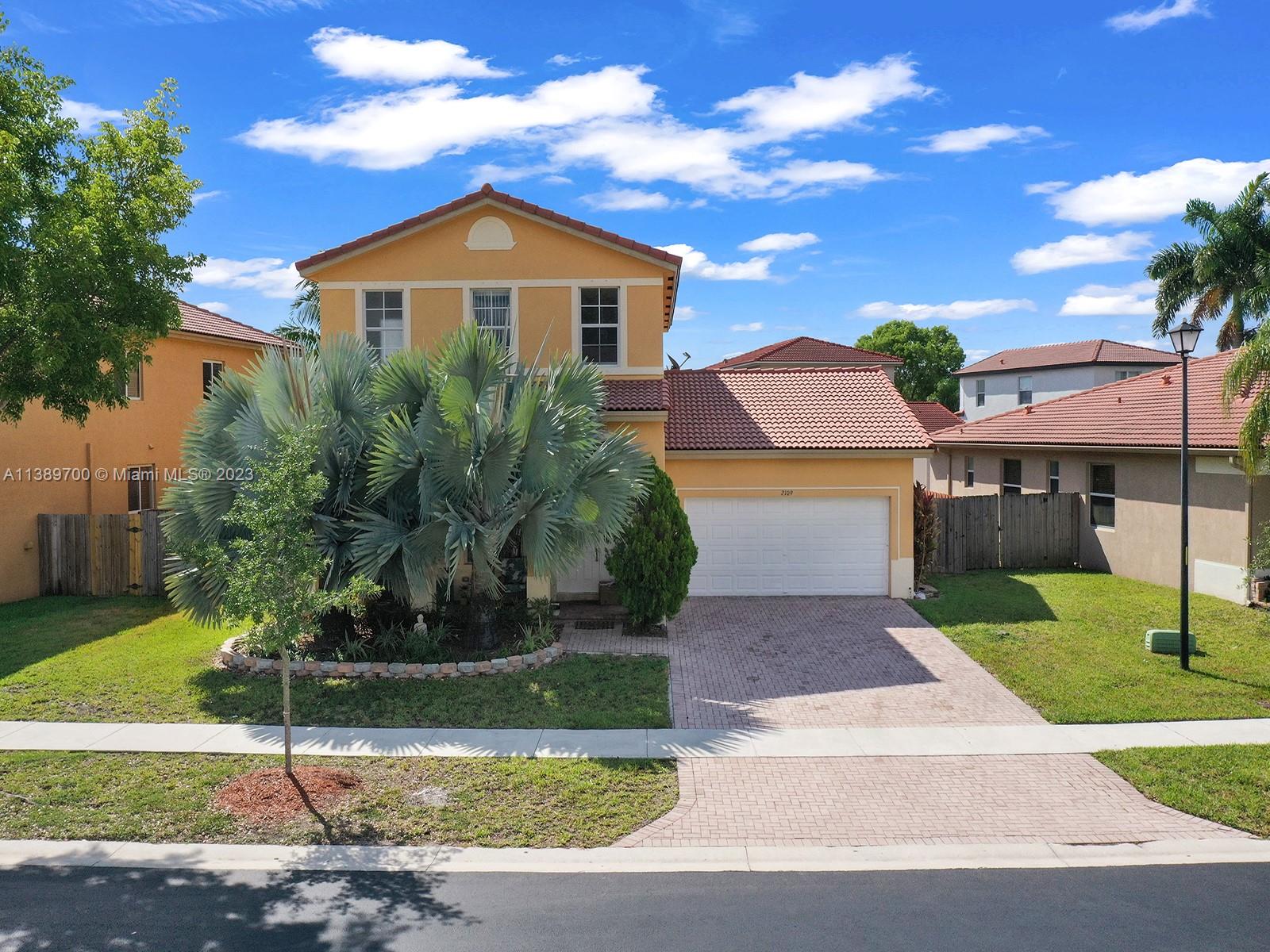 2109 Northeast 38th Road Homestead, FL 33033 - Photo 3 of 43 a front view of a house with a yard
