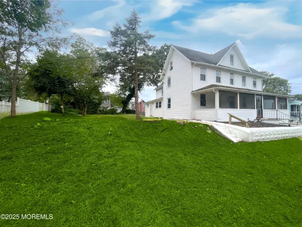 a kitchen with granite countertop a sink cabinets stainless steel appliances and a window