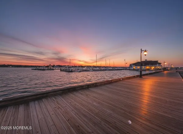 a view of a kitchen with wooden floor and a window
