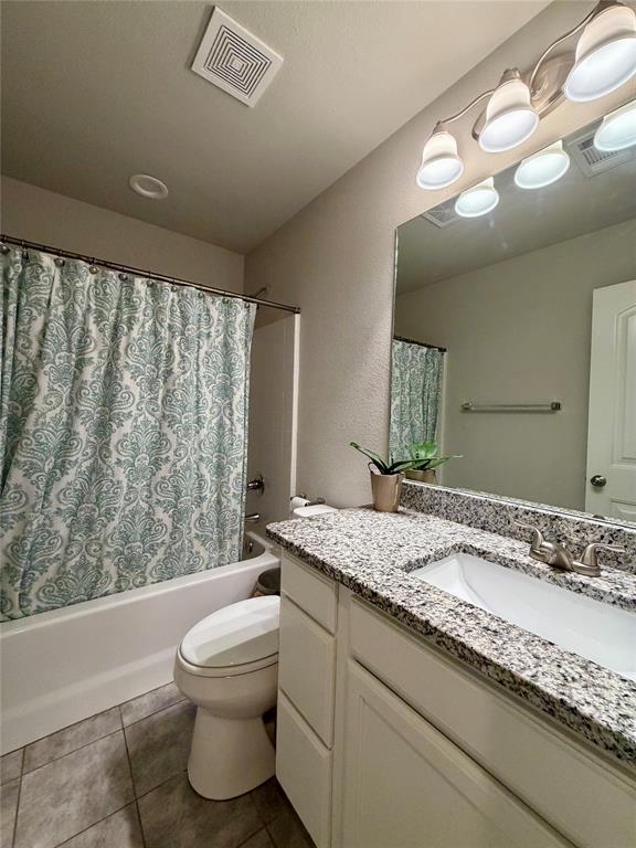 619 Mansfield Road Cleburne, TX 76031 - Photo 8 of 19 Bathroom featuring a white vanity with a speckled countertop, an undermount sink, and a large wall-mounted mirror