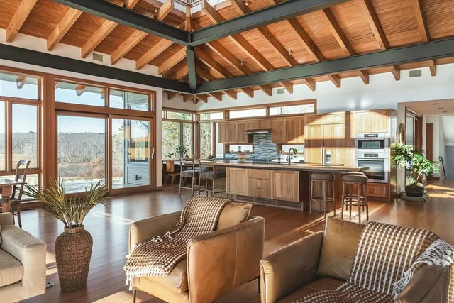 a living room with furniture and floor to ceiling windows