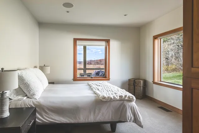 a living room with furniture and floor to ceiling windows