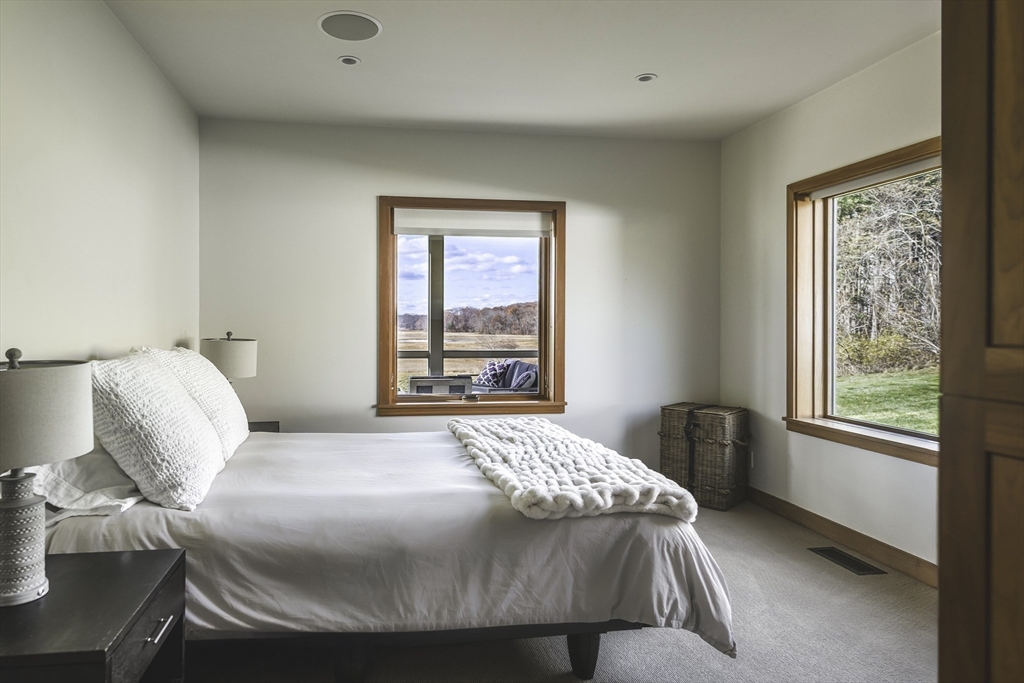 154 Argilla Road Ipswich, MA 01938 - Photo 16 of 42 a bedroom with a bed and a window