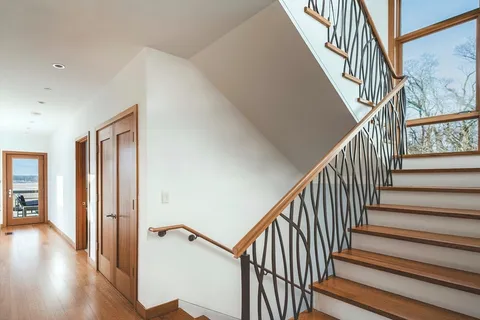 a room with a bed and a large window