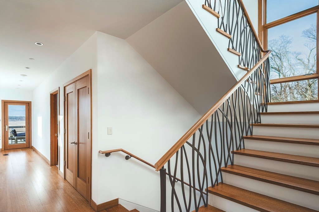 154 Argilla Road Ipswich, MA 01938 - Photo 21 of 42 a view of staircase with lots of frames on wall and wooden floor