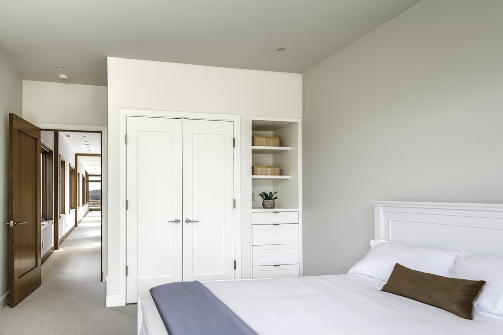 154 Argilla Road Ipswich, MA 01938 - Photo 28 of 42 a bedroom with a bed and a cabinets