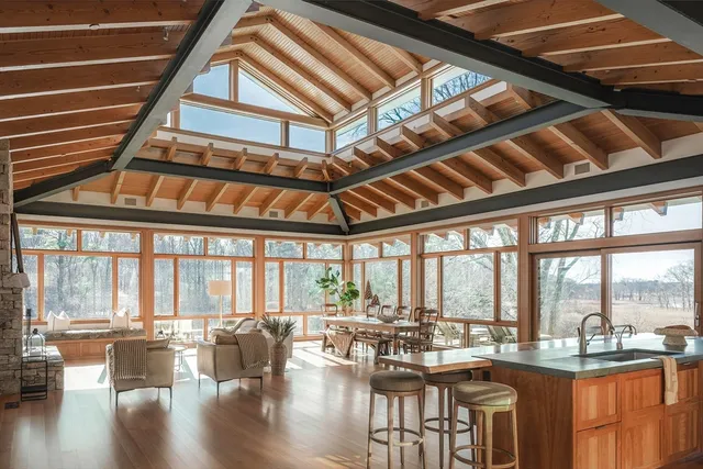 a very nice looking room with many windows and furniture