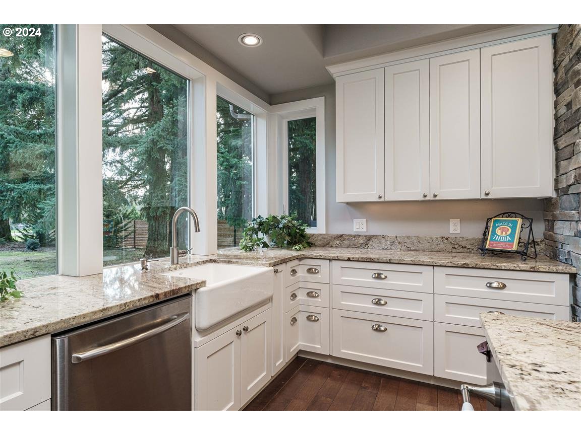 27015 Northeast Hathaway Road Camas, WA 98607 - Photo 14 of 48 a kitchen with granite countertop white cabinets and a large window