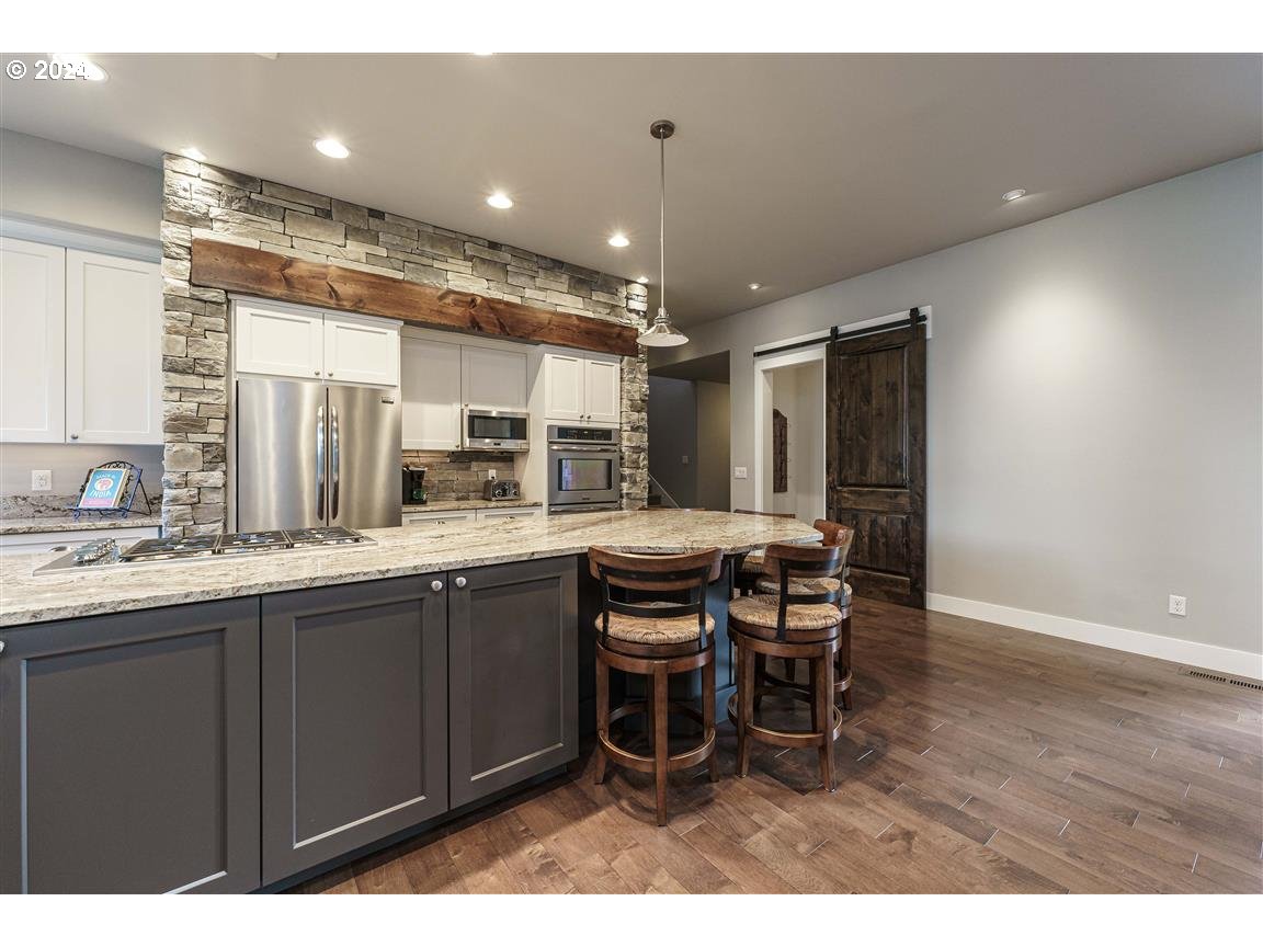 27015 Northeast Hathaway Road Camas, WA 98607 - Photo 17 of 48 a kitchen with a dining table chairs and wooden floor
