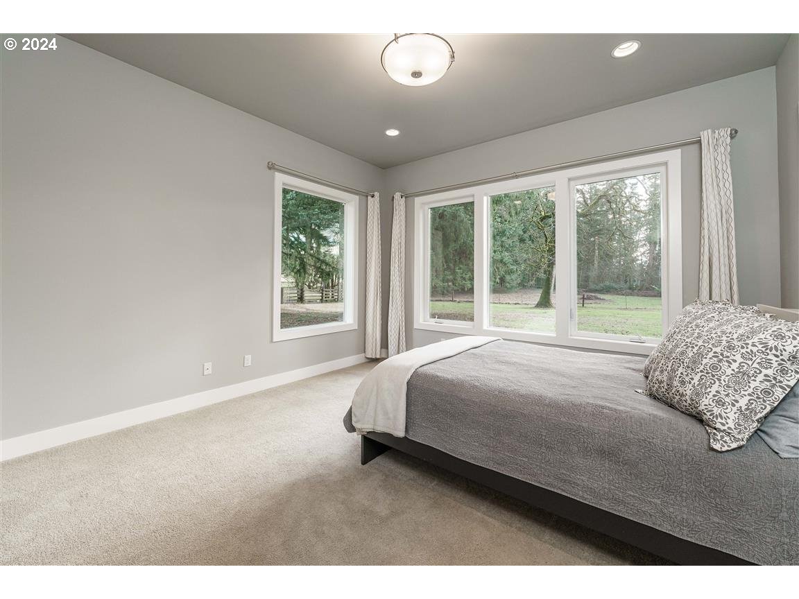 27015 Northeast Hathaway Road Camas, WA 98607 - Photo 20 of 48 a bedroom with a large bed and a large window