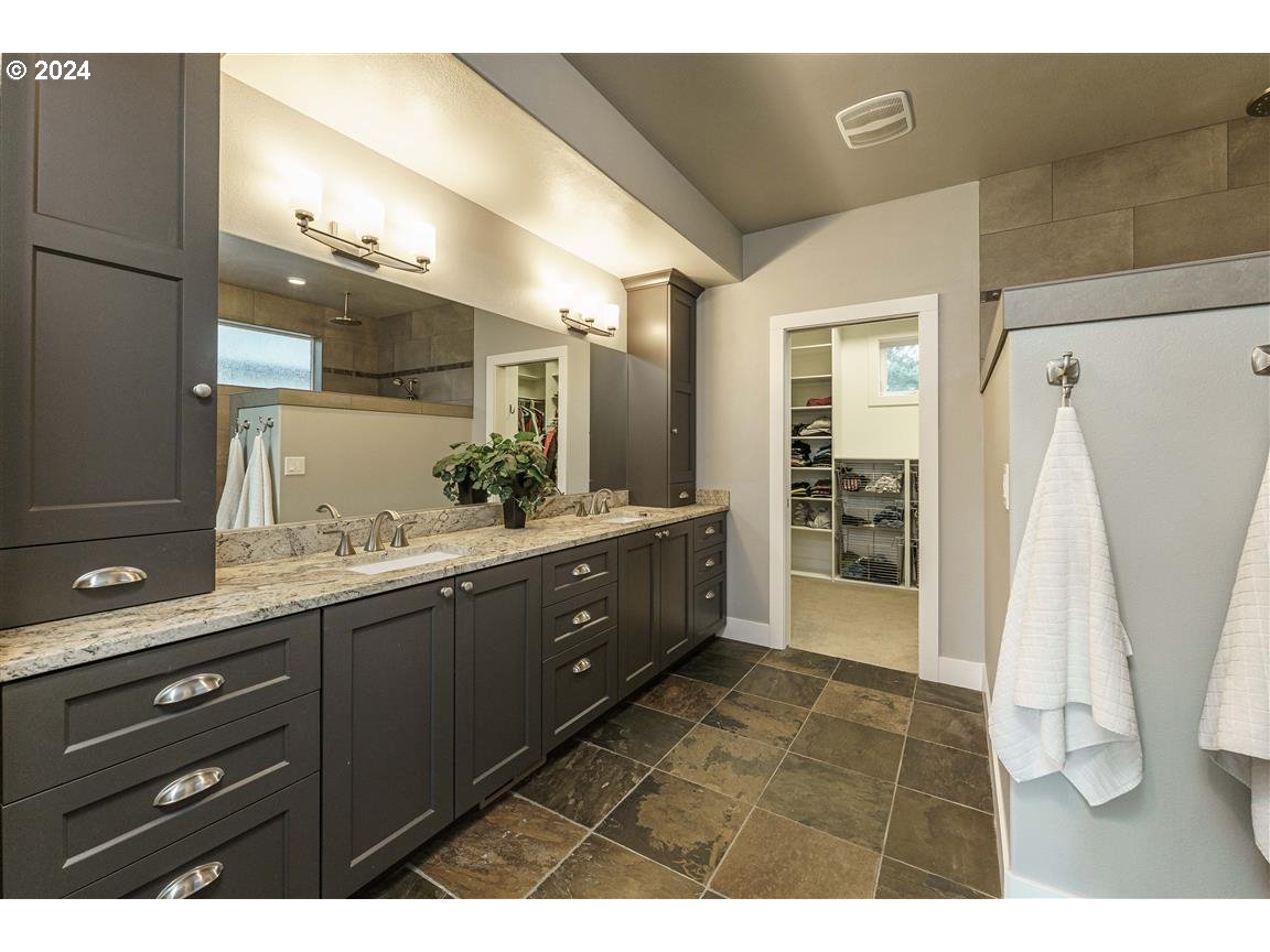 27015 Northeast Hathaway Road Camas, WA 98607 - Photo 21 of 48 a bathroom with a double vanity sink a mirror and a shower