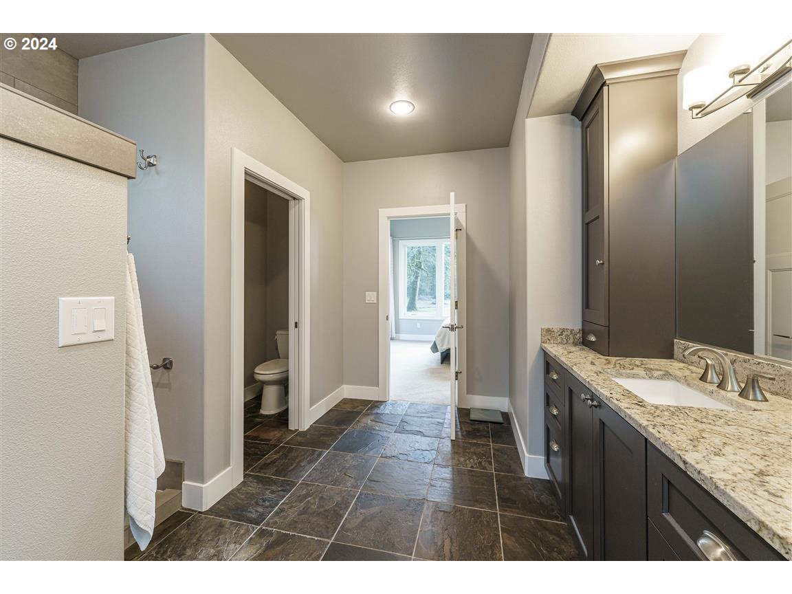 27015 Northeast Hathaway Road Camas, WA 98607 - Photo 22 of 48 a bathroom with a granite countertop sink a mirror and a shower