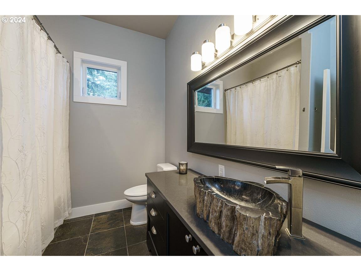 27015 Northeast Hathaway Road Camas, WA 98607 - Photo 27 of 48 a bathroom with a sink a toilet and mirror
