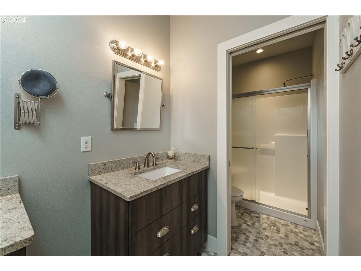 27015 Northeast Hathaway Road Camas, WA 98607 - Photo 33 of 48 a bathroom with a sink a light fixture and a mirror