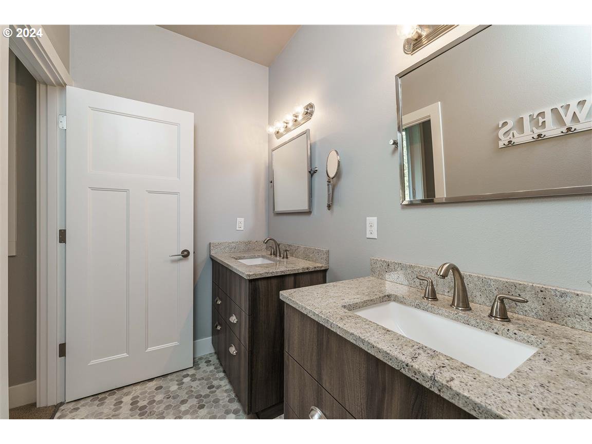 27015 Northeast Hathaway Road Camas, WA 98607 - Photo 34 of 48 a bathroom with a granite countertop sink and a mirror
