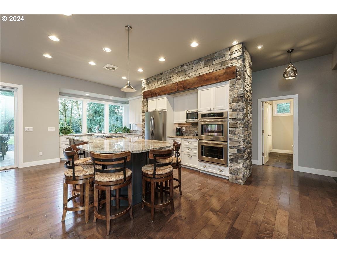 27015 Northeast Hathaway Road Camas, WA 98607 - Photo 9 of 48 a dining area with a table chairs and a kitchen view