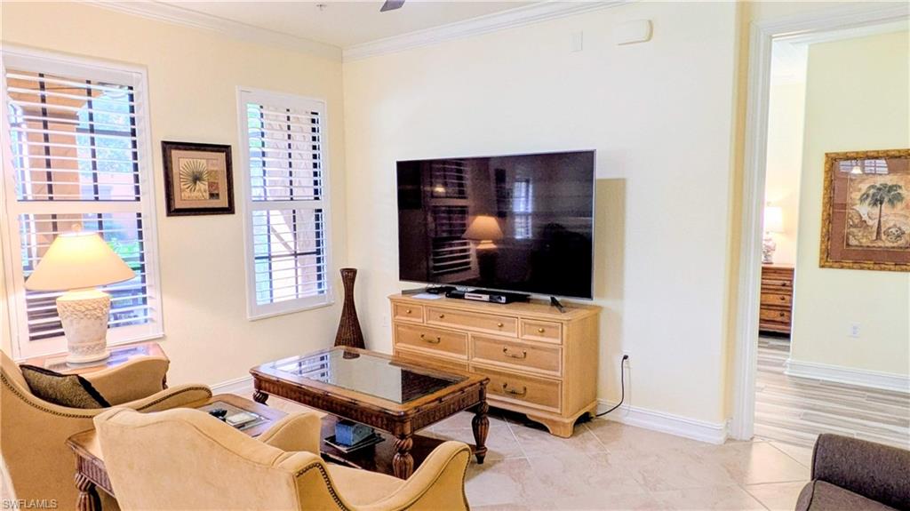 9081 Albion Lane South, Unit 6505 Naples, FL 34113 - Photo 12 of 41 a living room with furniture and a flat screen tv