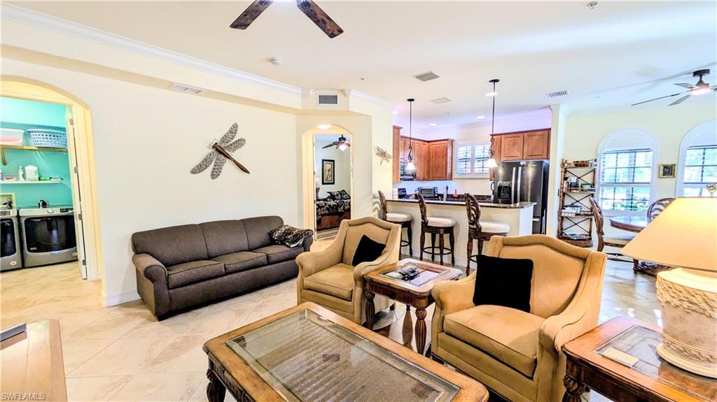 9081 Albion Lane South, Unit 6505 Naples, FL 34113 - Photo 14 of 41 a living room with furniture kitchen view and a chandelier