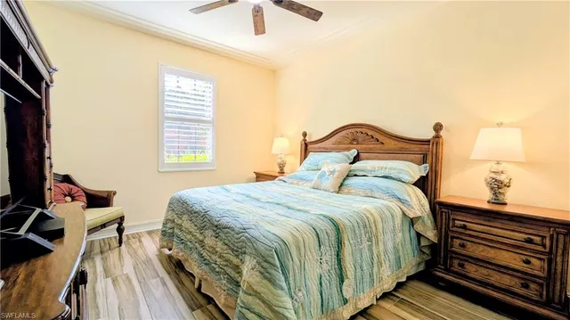 a bedroom with a bed and a flat tv screen on dresser