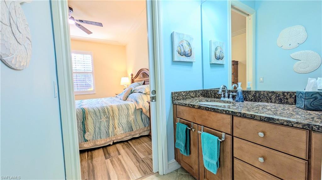 9081 Albion Lane South, Unit 6505 Naples, FL 34113 - Photo 18 of 41 a en suite bathroom with a granite countertop sink and a mirror