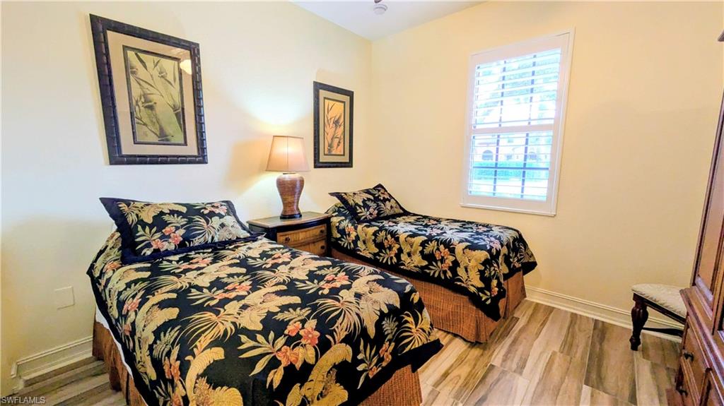 9081 Albion Lane South, Unit 6505 Naples, FL 34113 - Photo 21 of 41 a bed sitting in a bedroom next to a window