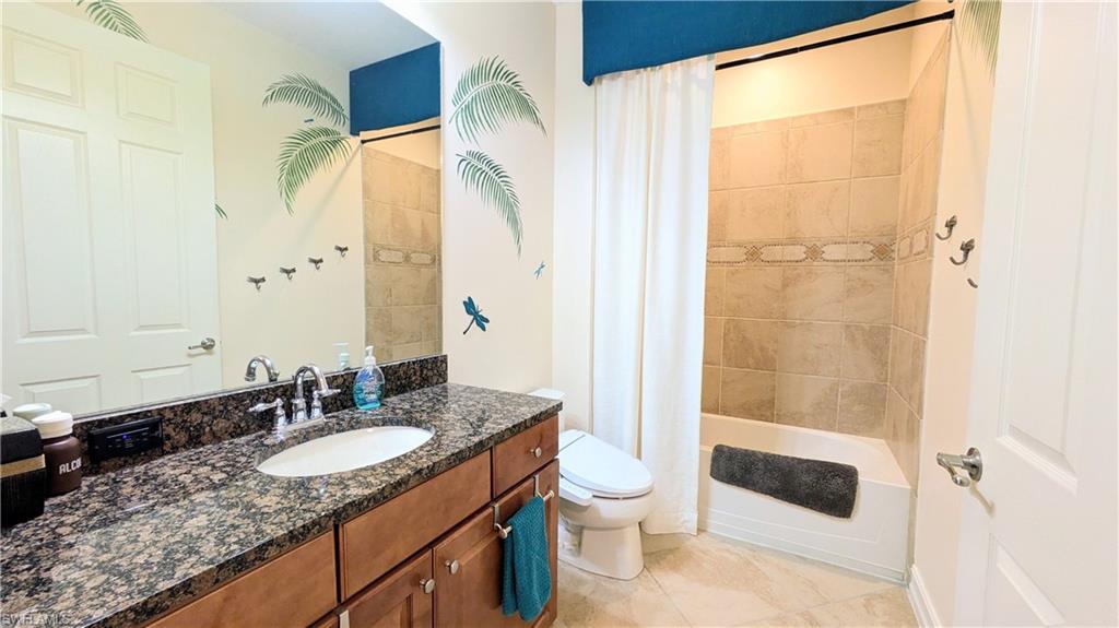 9081 Albion Lane South, Unit 6505 Naples, FL 34113 - Photo 22 of 41 a bathroom with a granite countertop sink toilet and shower