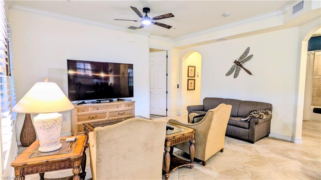 9081 Albion Lane South, Unit 6505 Naples, FL 34113 - Photo 6 of 41 a living room with furniture and a flat screen tv
